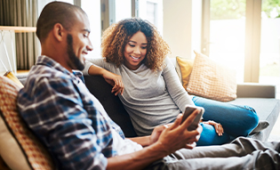 Couple looking at window film benefits on mobile device